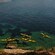 5 people kayaking near a coastline